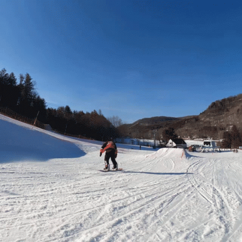 someone is skiing down a snowy hill on a ski slope