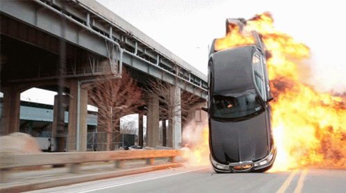 a car with blue flames burning out of it's tires on a highway