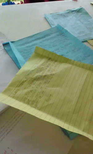 a number of pieces of paper with a person in the background