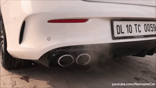 a rear view of a car smoking it's exhaust