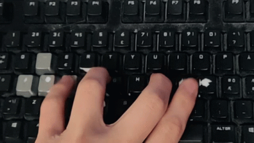 a computer keyboard with hands on it