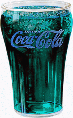 a green glass full of coca cola sitting on a white table