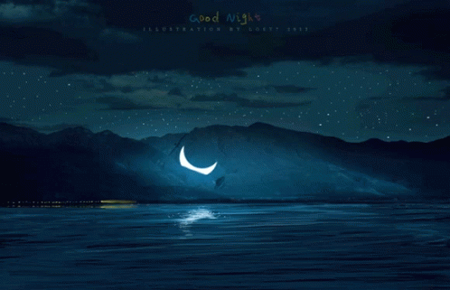 the moon is above a dark mountain with a body of water