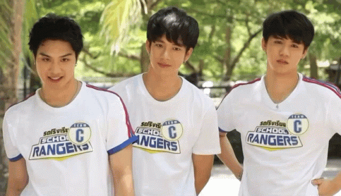 three asian men are standing together in matching t shirts