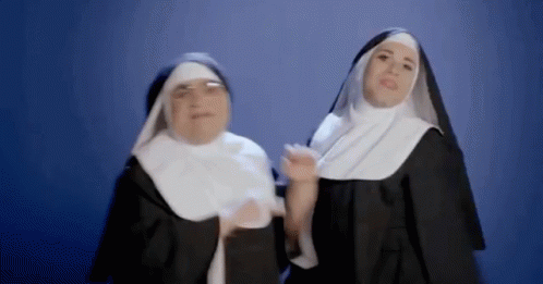 two people in nun dresses are shown with their hands together