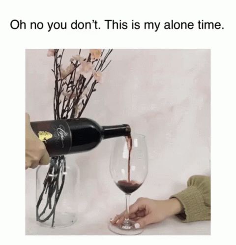 someone pours a glass of red wine