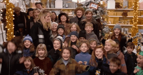 a group of children sing christmas carols while standing in front of their decorated windows