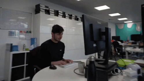 a person sitting at a desk in an office