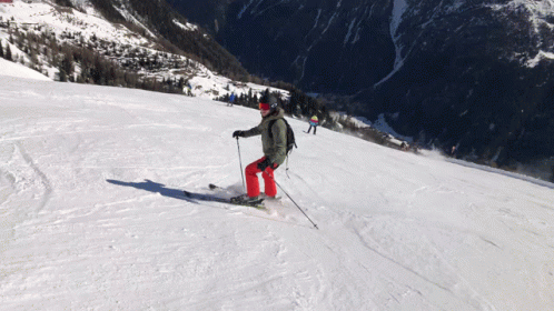 skiers going down a mountain on their skiis