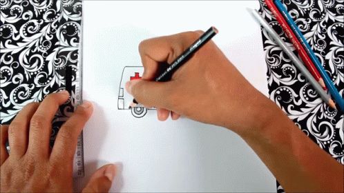 a person drawing on a piece of paper