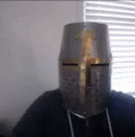a person is wearing a silver paper mask