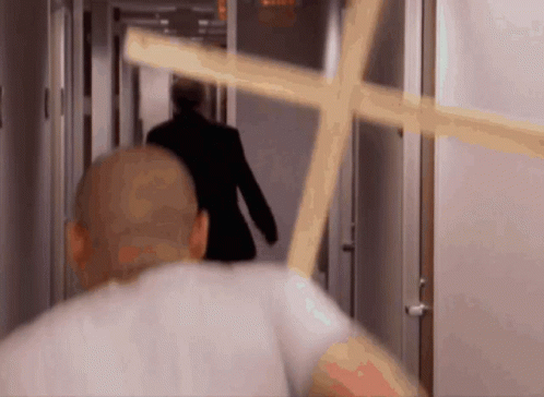 someone walking through an elevator with a cross in the hallway