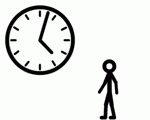 man is standing in front of a clock and pointing at it
