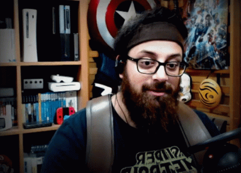 a man wearing glasses and a captain america hat in his room