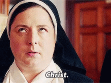 a young woman in a nun costume has her eyes closed