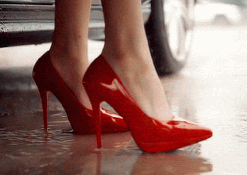 the legs of a woman wearing blue high heels