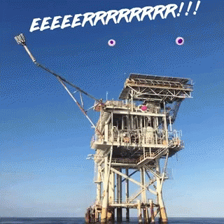 the back side of an oil rig in the water