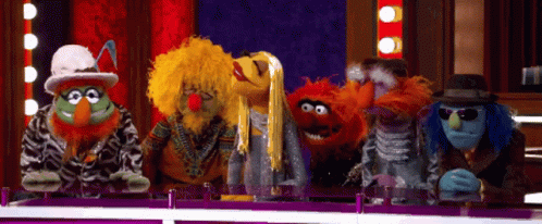 the three sesame street characters are on stage