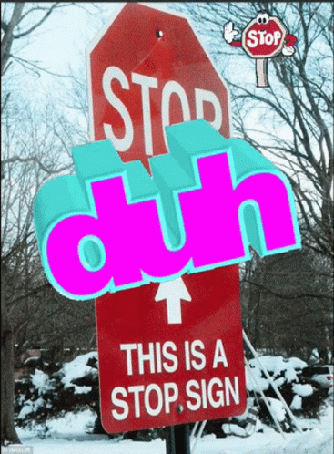 the blue stop sign has a neon pink letter on it