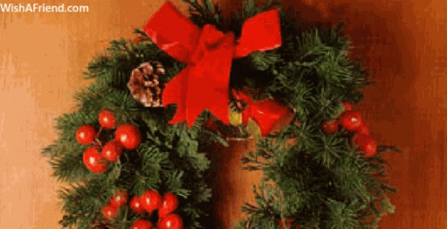 a christmas wreath with balls, berries and pine cones