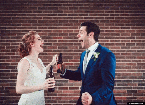 the two people are smiling for each other while holding champagne