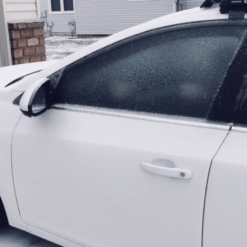 a white car has snow on it as the rear end