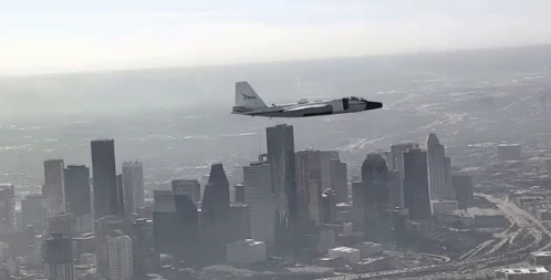 an old airplane flies over a city skyline