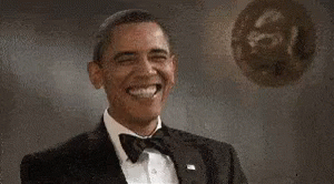 president obama is smiling while he wears a tuxedo