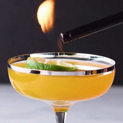 a cigarette being lit over the blue margarita