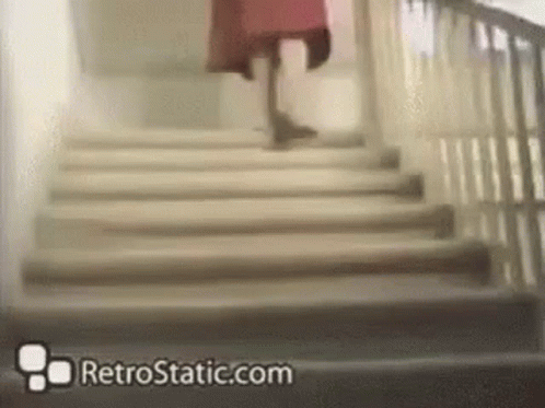 a lady with a coat is walking down the stairs
