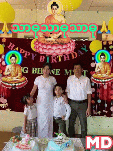 an image of a man, woman and child posing in front of birthday cake