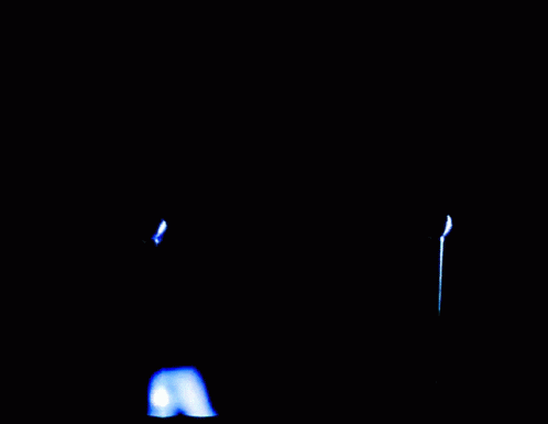 two lit candles on a black background