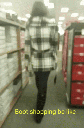 a woman is in a store surrounded by aisles of shelves with boxes