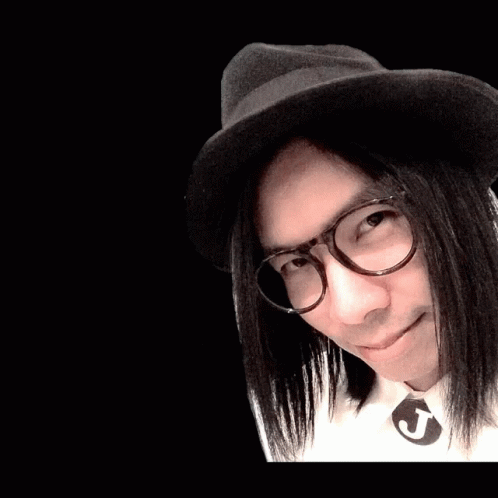 an asian man with long black hair and a fedora