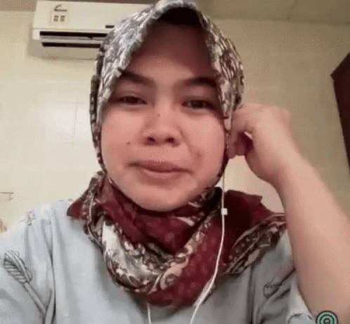an asian woman with a head scarf around her heads