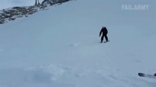 two snowboarders make their way down a snowy hill
