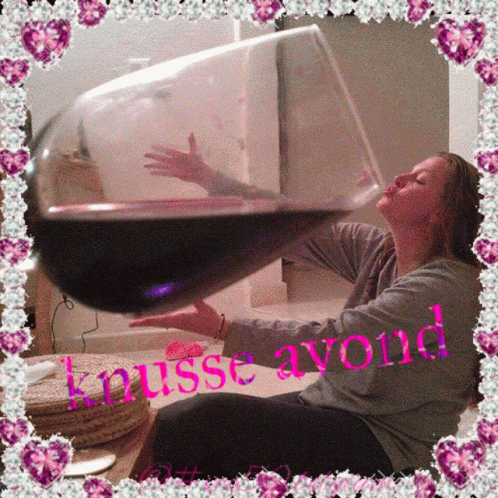 a woman sitting down next to a wine glass