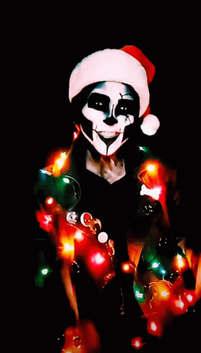 a skeleton dressed up with christmas lights in his hands