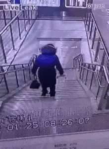 the person is walking down the stair case