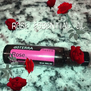 a bottle with rose essential oil on a table