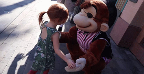 a person in a blue monkey suit shaking hands with a cartoon character