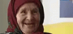 a lady in hoodie making funny faces with her phone