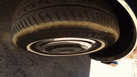 a close up of a car's tire laying on a curb