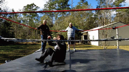 two people on a dock with rope and one person in black holding a skateboard