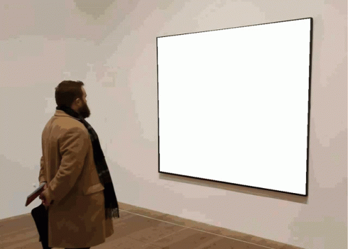 a person standing in front of a large square screen