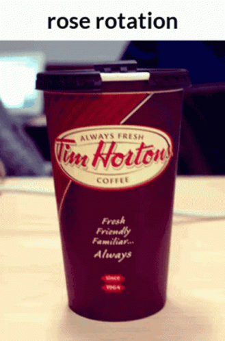 a blue cup sits on a table with the name tim horton's coffee on it