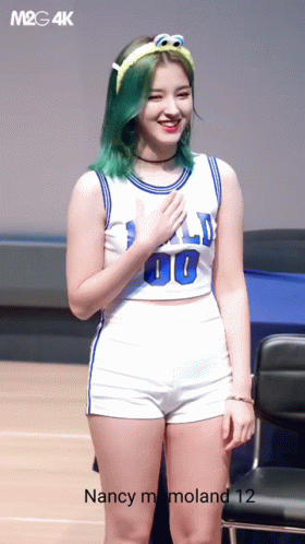 a woman wearing shorts, a basketball jersey and heels