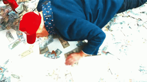 there is a child with his arms outstretched on a bed covered in money