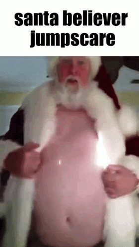 a man in santa claus costume playing with a baby