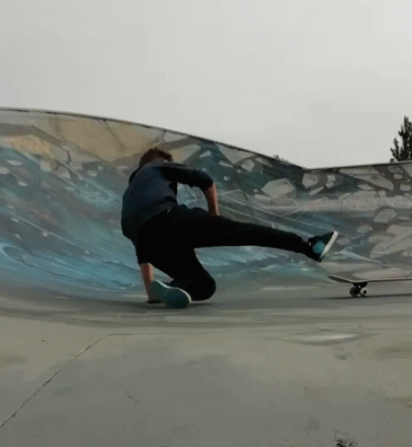 a young skateboarder grinds a skate ramp in a halfpipe